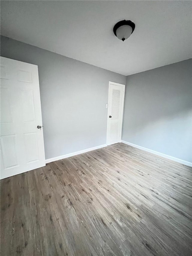 unfurnished room featuring wood-type flooring