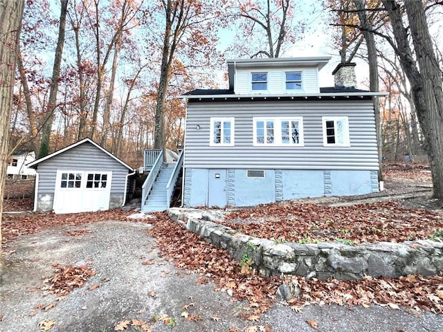 view of front facade featuring a garage and an outbuilding