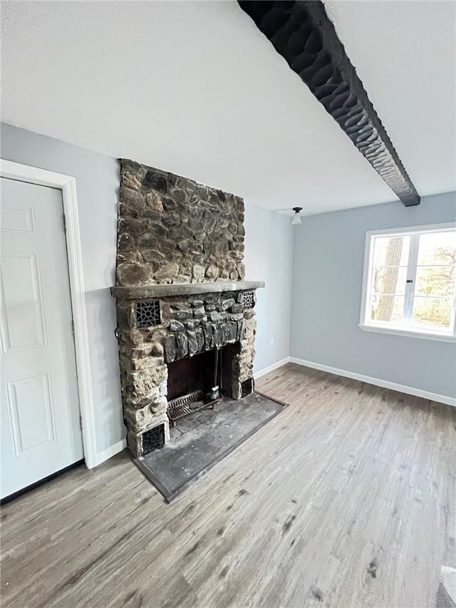 unfurnished living room with a fireplace and hardwood / wood-style floors