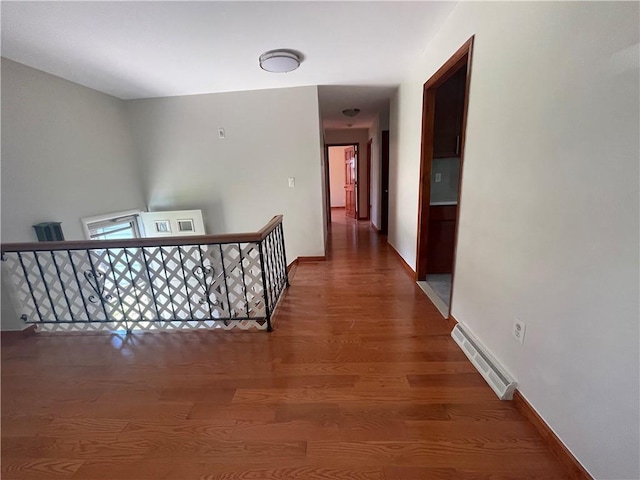 corridor with dark hardwood / wood-style flooring