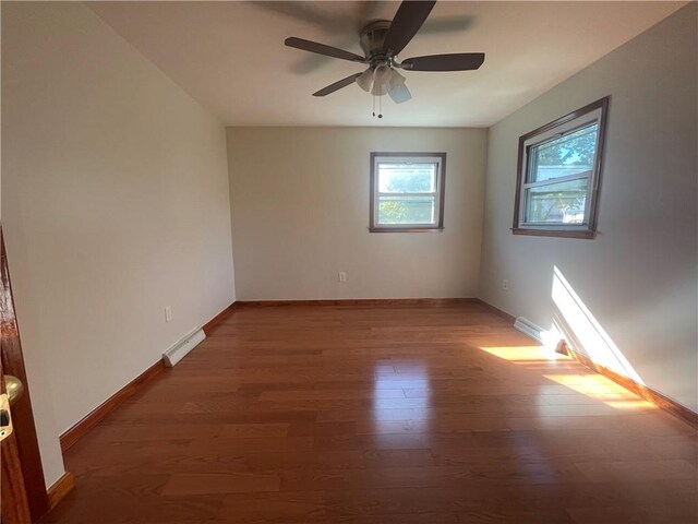 unfurnished room featuring dark hardwood / wood-style flooring and ceiling fan