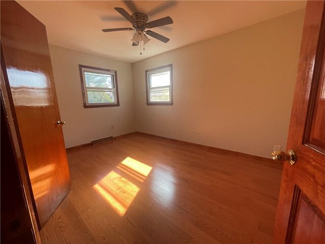 empty room featuring ceiling fan and light wood-type flooring