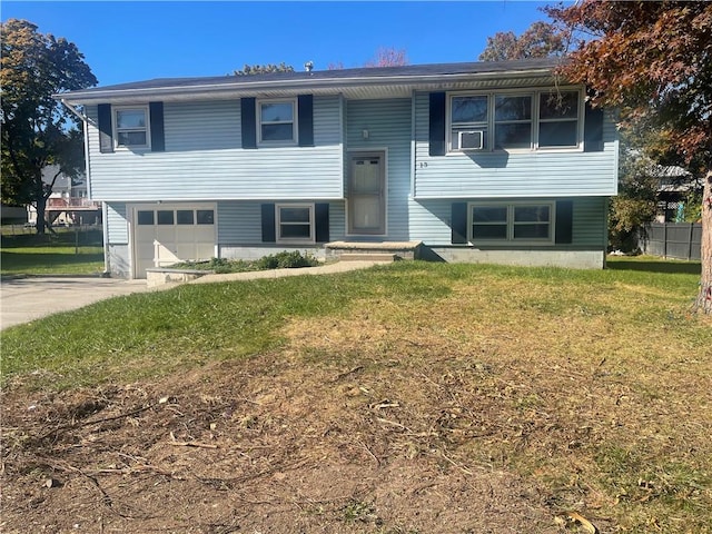 bi-level home featuring a front lawn and a garage