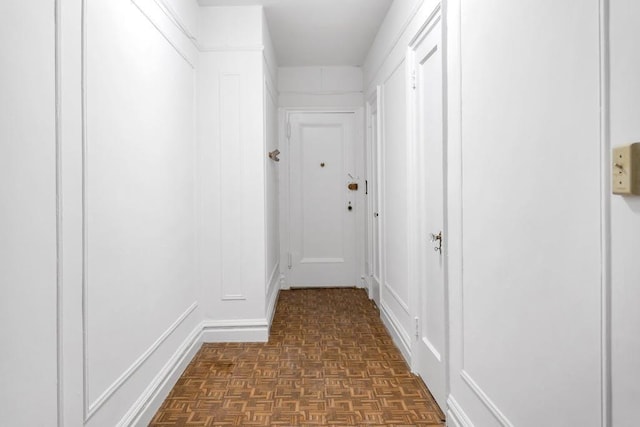 hall with dark parquet flooring