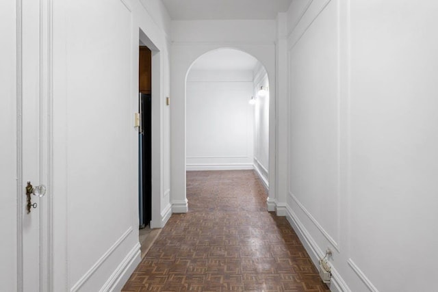 corridor with dark parquet flooring