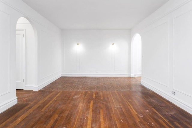 empty room with dark hardwood / wood-style flooring