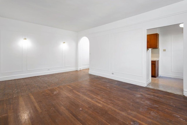 spare room with dark hardwood / wood-style floors