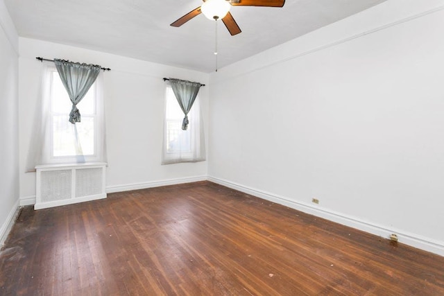 spare room featuring dark hardwood / wood-style floors and ceiling fan