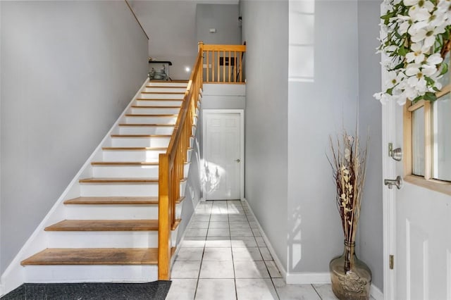 staircase with tile patterned flooring and baseboards