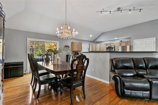 dining space featuring lofted ceiling, light wood finished floors, and a notable chandelier