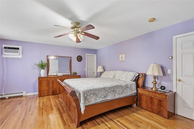 bedroom featuring baseboards, a ceiling fan, light wood-style flooring, a wall mounted air conditioner, and baseboard heating