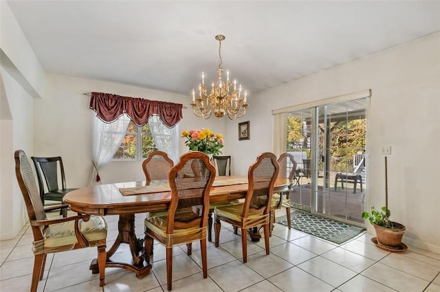 dining space with light tile patterned floors and an inviting chandelier