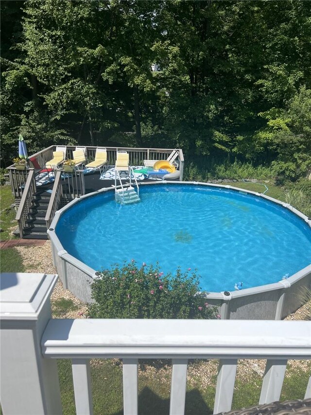 outdoor pool featuring a deck and stairway