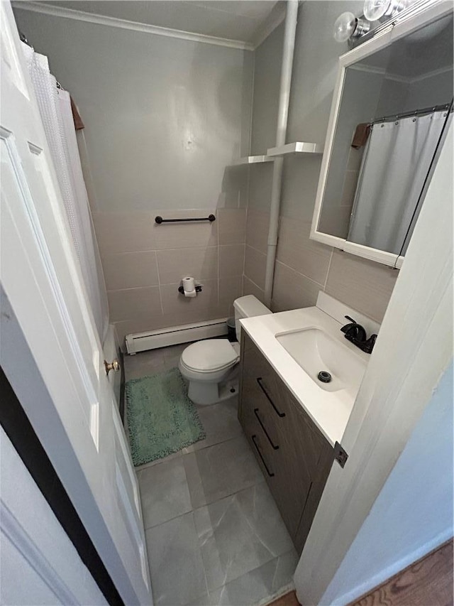 bathroom with vanity, baseboard heating, tile walls, tile patterned flooring, and toilet