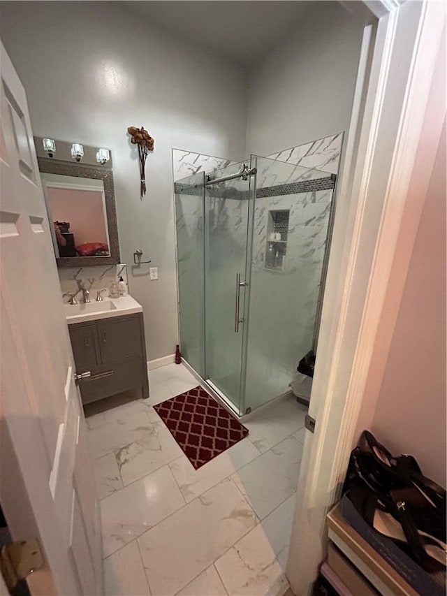 bathroom featuring vanity and an enclosed shower