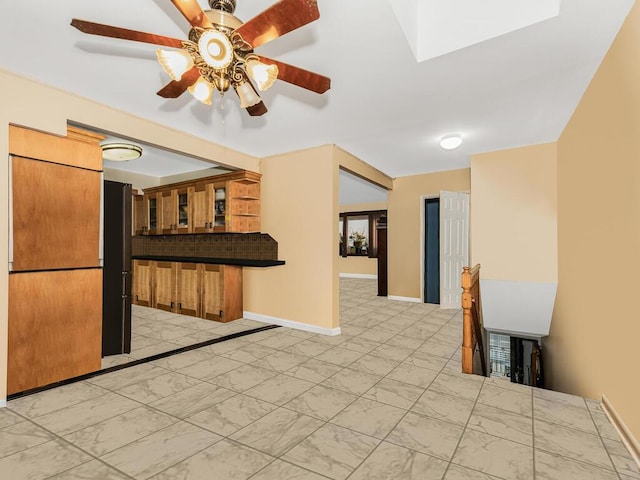 kitchen with a skylight and ceiling fan