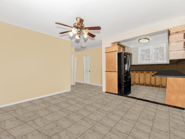 kitchen with ceiling fan and black fridge