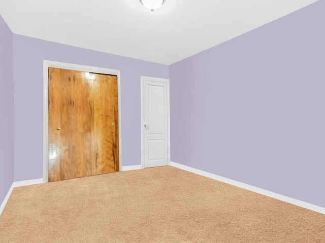 unfurnished bedroom with a closet and carpet floors