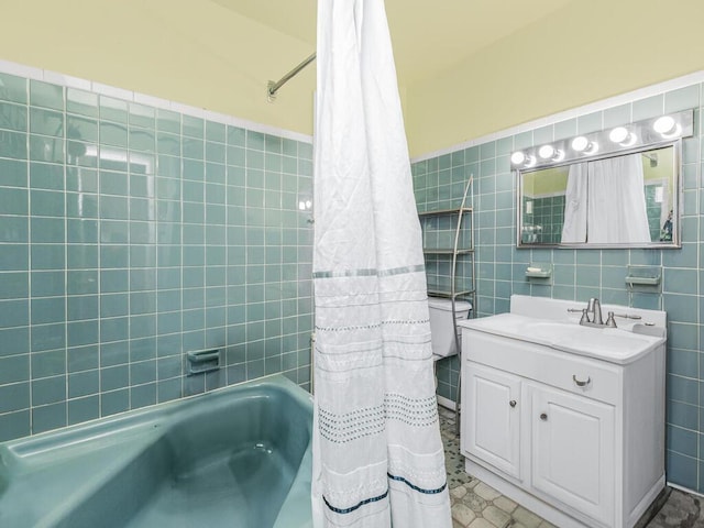 full bathroom with shower / bath combo with shower curtain, vanity, tile walls, and toilet