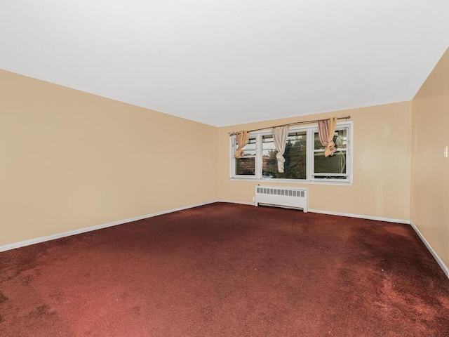 unfurnished living room featuring carpet flooring and radiator