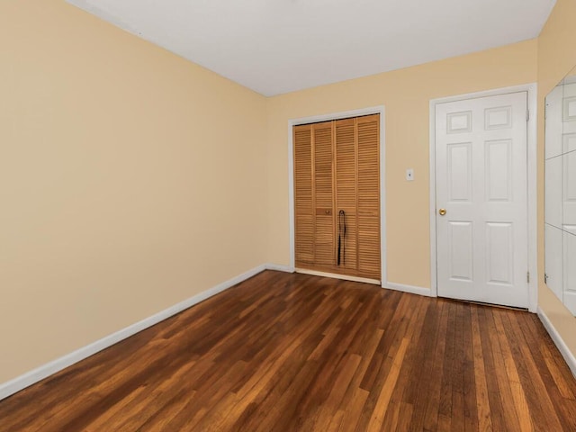 unfurnished bedroom with dark wood-type flooring