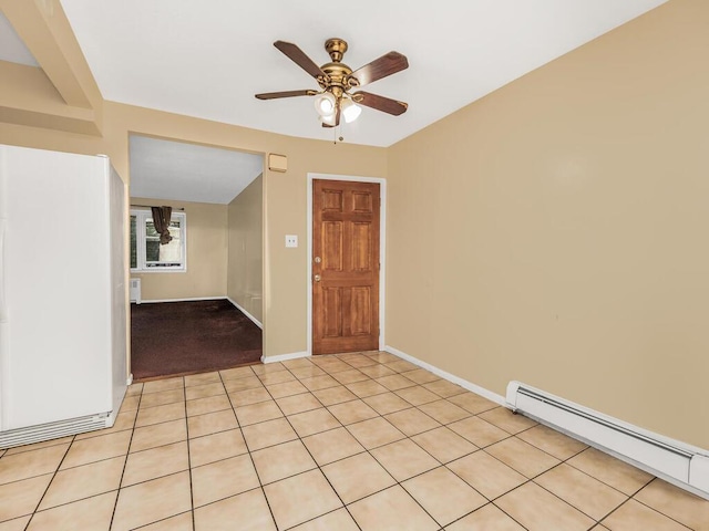 tiled empty room with ceiling fan and a baseboard radiator