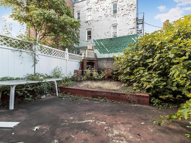 view of patio with a brick fireplace