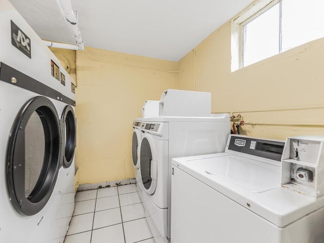 laundry area featuring washer and dryer and light tile patterned floors