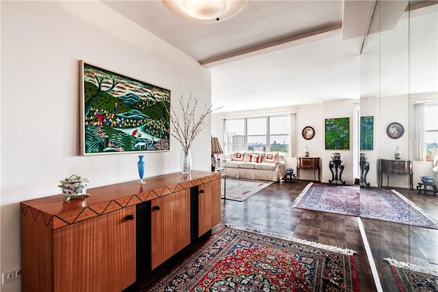 interior space featuring beam ceiling and dark parquet flooring