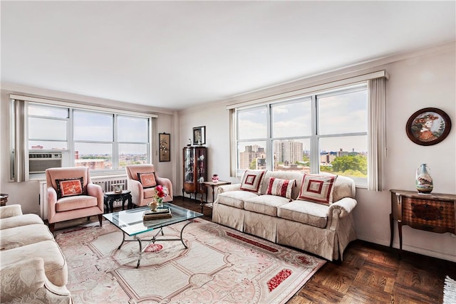 living room with dark parquet floors and ornamental molding