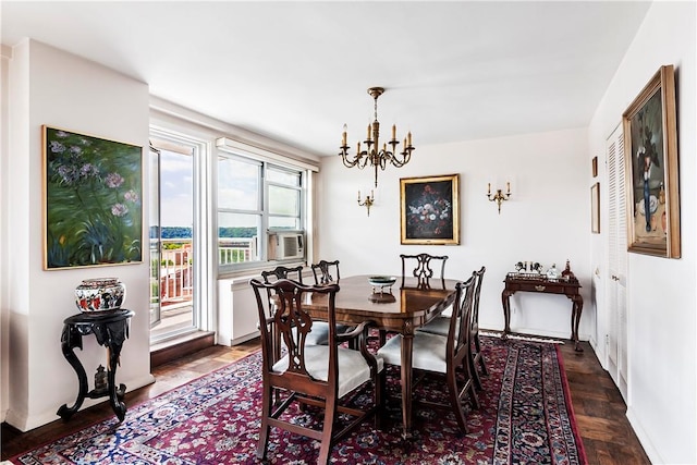 dining space featuring a notable chandelier, cooling unit, and dark wood-type flooring