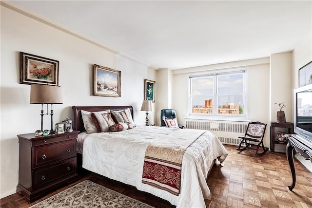 bedroom with radiator heating unit and parquet floors