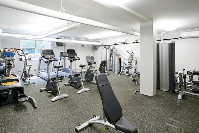 exercise room with a wall mounted AC