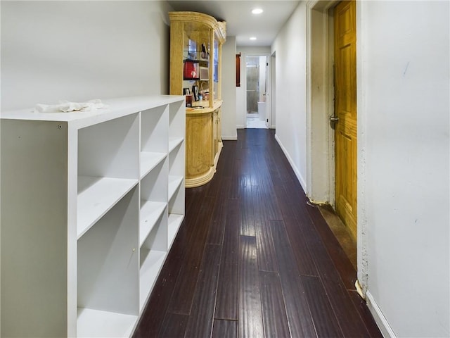 hall with dark hardwood / wood-style floors