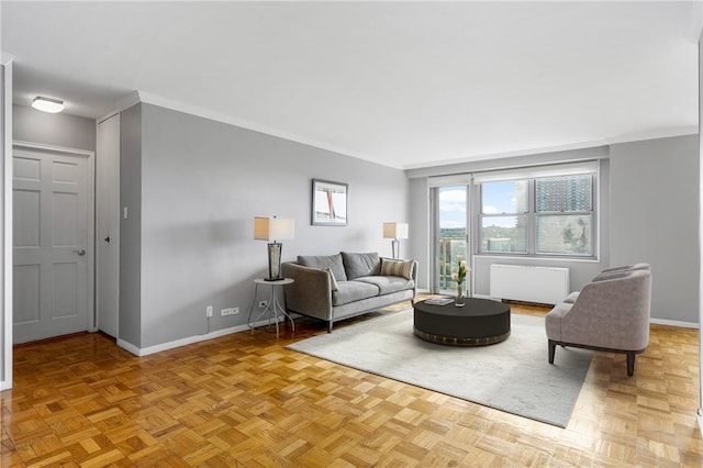 living room featuring radiator, light parquet floors, and ornamental molding