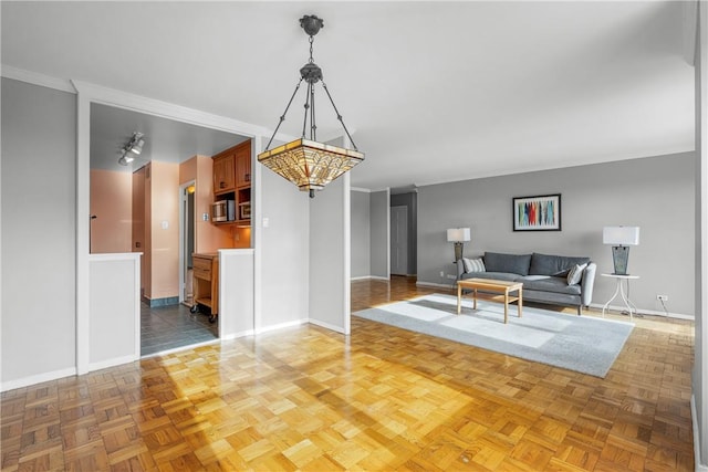 living room with dark parquet flooring and ornamental molding