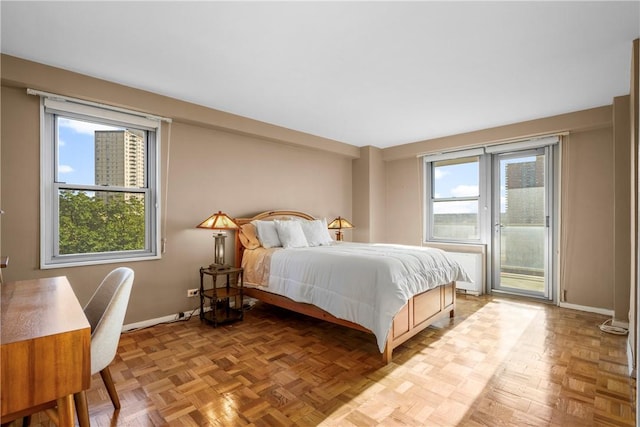 bedroom with access to exterior and light parquet floors