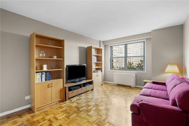 living room featuring radiator heating unit and light parquet floors