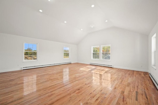 unfurnished living room with light wood-type flooring, a wealth of natural light, and a baseboard radiator