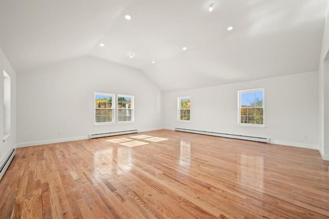 additional living space with light hardwood / wood-style floors, vaulted ceiling, and a baseboard radiator