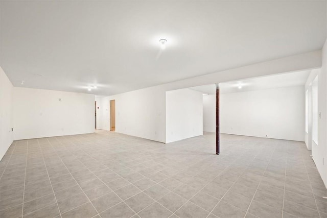 basement featuring light tile patterned flooring