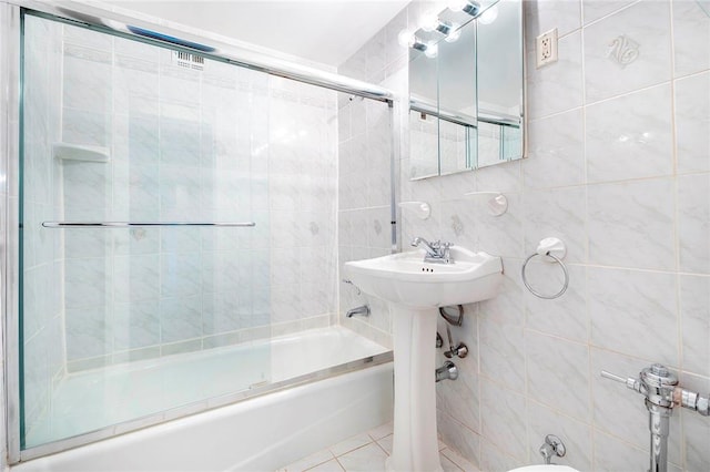 bathroom featuring tasteful backsplash, tile patterned floors, tile walls, and combined bath / shower with glass door