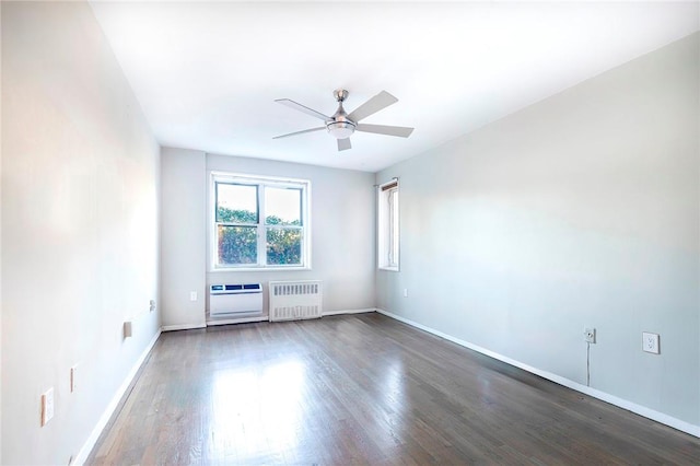 empty room with radiator heating unit, dark hardwood / wood-style floors, and ceiling fan