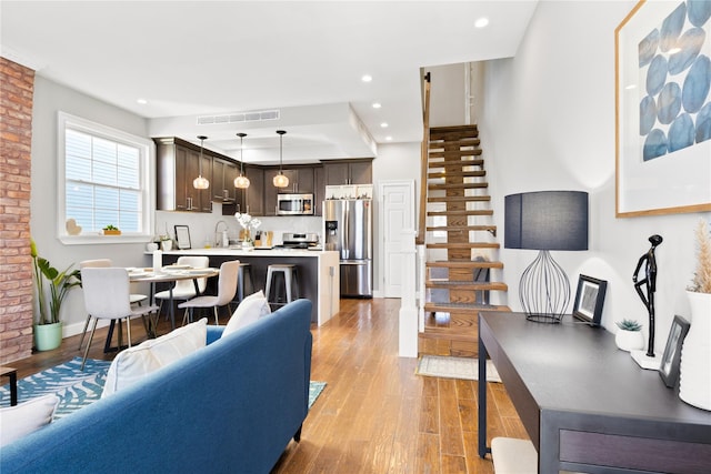 living room featuring light hardwood / wood-style floors and sink