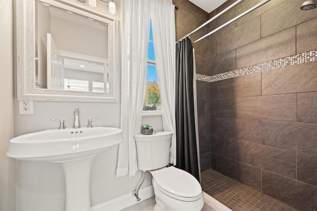 bathroom featuring curtained shower and toilet