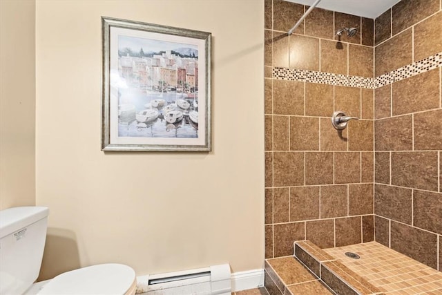 bathroom featuring a tile shower, toilet, and baseboard heating