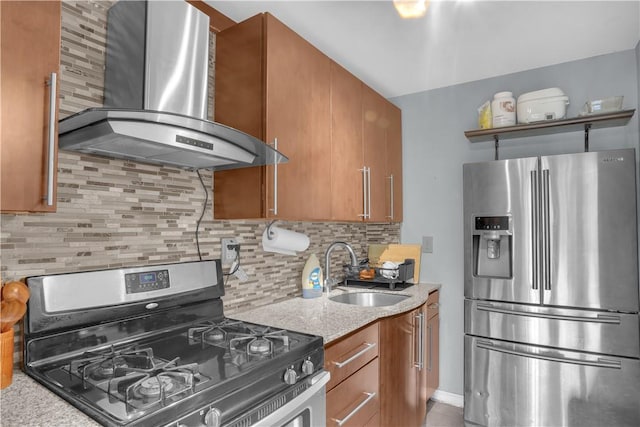 kitchen featuring light stone countertops, sink, wall chimney exhaust hood, tasteful backsplash, and appliances with stainless steel finishes