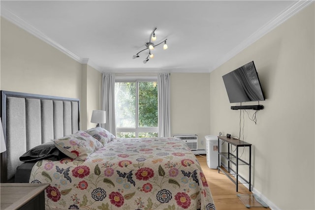 bedroom with light hardwood / wood-style floors, an AC wall unit, and crown molding