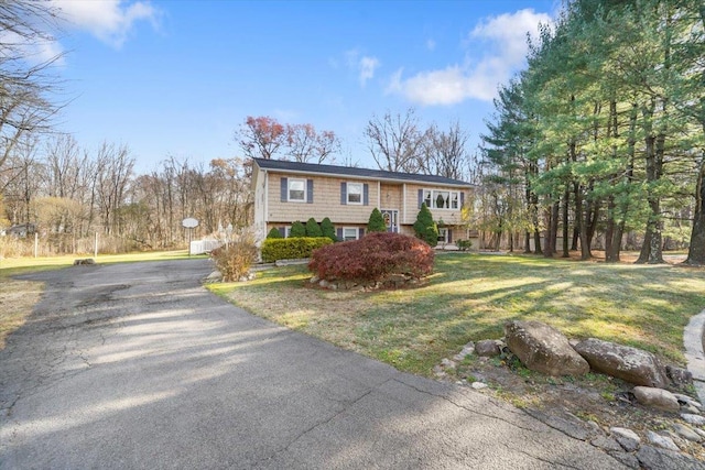 raised ranch with a front yard