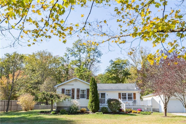 ranch-style home featuring a wooden deck and a front yard